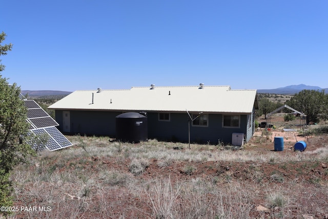 1155 W Half Moon Ct, Ash Fork, AZ 86320 - back of property with solar panels, metal roof, and a mountain view