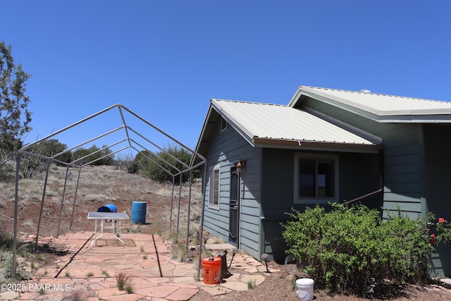 1155 W Half Moon Ct, Ash Fork, AZ 86320 - view of side of home with a patio area and metal roof