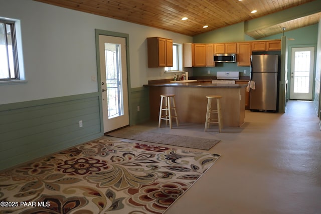 1155 W Half Moon Ct, Ash Fork, AZ 86320 - kitchen featuring appliances with stainless steel finishes, wood ceiling, a peninsula, dark countertops, and plenty of natural light