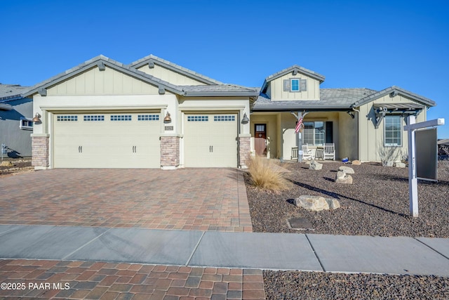 view of front of property featuring covered porch and a garage