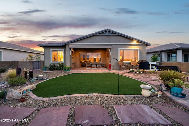 5313 Autumn Leaf Ln, Prescott, AZ 86301 - back of house at dusk with stucco siding, a patio, and outdoor dining space