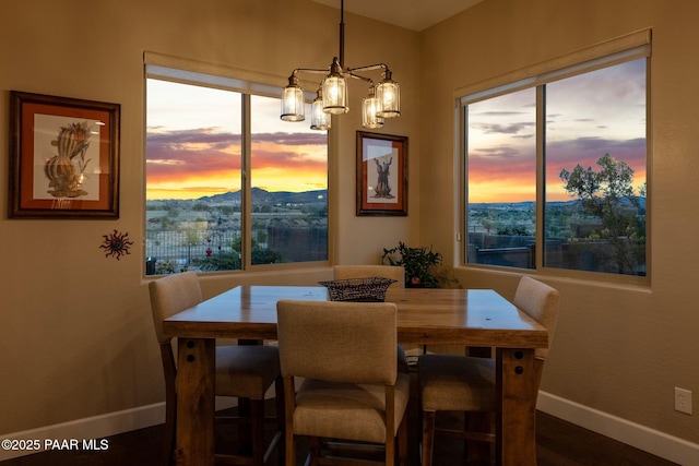 5313 Autumn Leaf Ln, Prescott, AZ 86301 - dining room with baseboards, dark wood-style flooring, a chandelier, and a mountain view