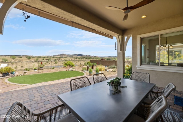 5313 Autumn Leaf Ln, Prescott, AZ 86301 - fenced backyard with a patio area, outdoor dining space, a ceiling fan, and a mountain view