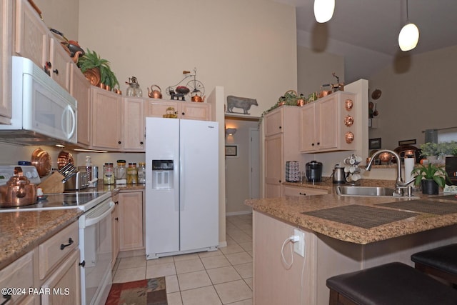 kitchen with light brown cabinetry, sink, hanging light fixtures, and white appliances