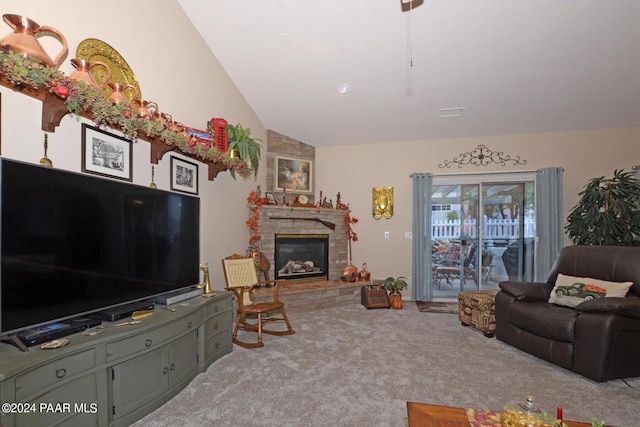 living room with carpet floors, a stone fireplace, and lofted ceiling