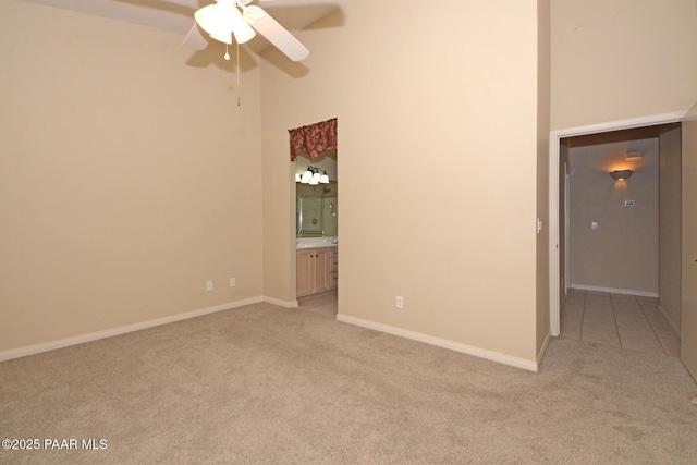 2091 E Oxford, Prescott Valley, AZ 86314 - spare room with light colored carpet, a ceiling fan, a towering ceiling, and baseboards