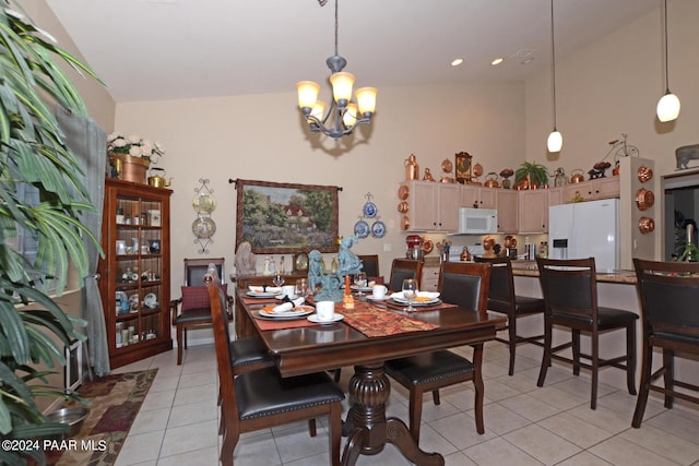 tiled dining space with a notable chandelier and high vaulted ceiling