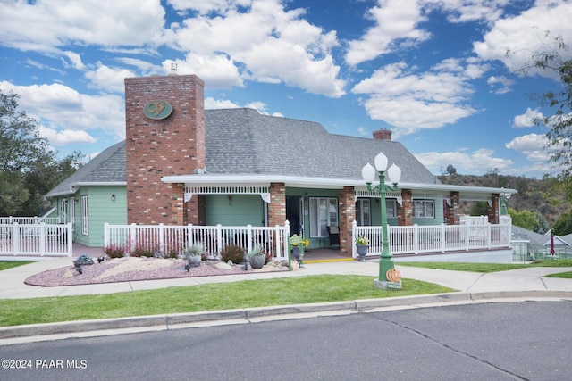 2091 E Oxford, Prescott Valley, AZ 86314 - view of front of home featuring covered porch, a chimney, and brick siding