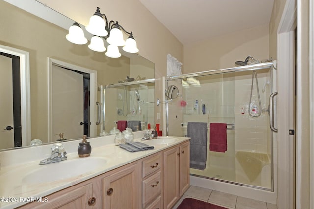 bathroom featuring vanity, tile patterned floors, a shower with door, and a notable chandelier