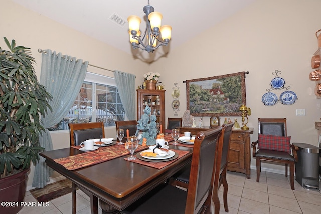 tiled dining space featuring a chandelier