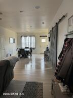 living room featuring a barn door and wood-type flooring