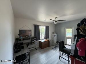 interior space with ceiling fan, a wealth of natural light, and light hardwood / wood-style flooring