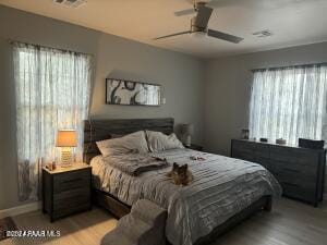 bedroom with ceiling fan and light wood-type flooring