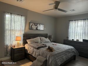 bedroom featuring multiple windows, ceiling fan, and light hardwood / wood-style floors