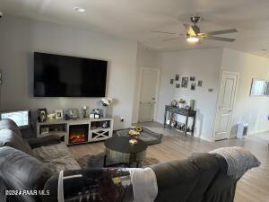 living room with hardwood / wood-style floors and ceiling fan