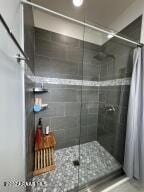 bathroom with tiled shower