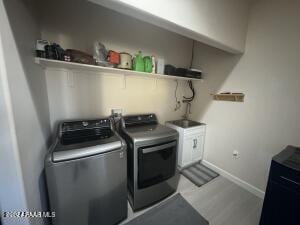 clothes washing area featuring washer and clothes dryer