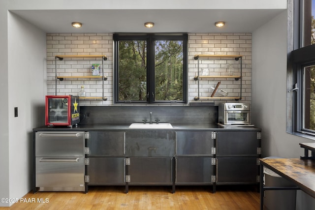 51 Rill Rd, Prescott, AZ 86305 - bar featuring a sink, light wood-type flooring, and decorative backsplash