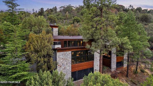 51 Rill Rd, Prescott, AZ 86305 - rear view of property with stone siding, a wooded view, a chimney, and a balcony