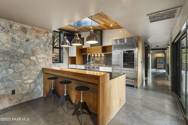 51 Rill Rd, Prescott, AZ 86305 - kitchen with stainless steel built in refrigerator, concrete floors, butcher block countertops, and modern cabinets