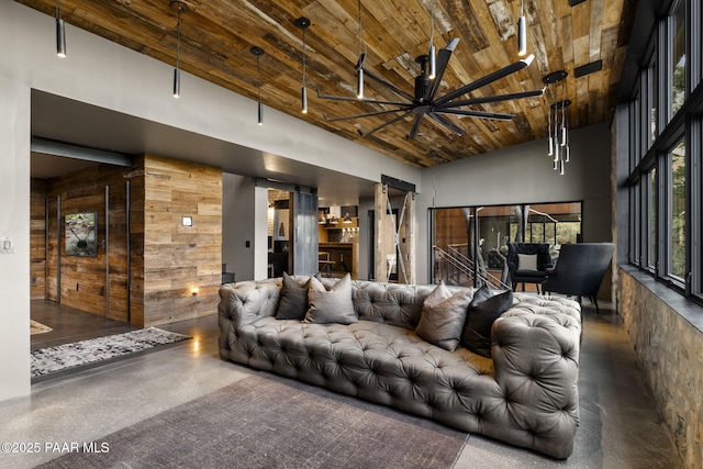 51 Rill Rd, Prescott, AZ 86305 - living area with wooden walls, wooden ceiling, ceiling fan, high vaulted ceiling, and concrete floors