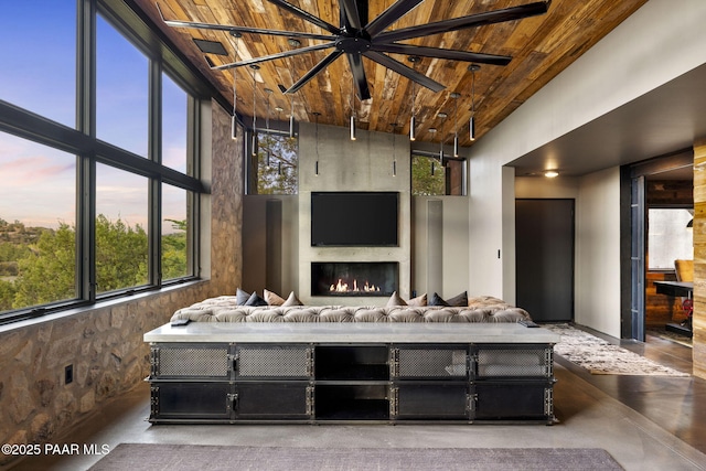 51 Rill Rd, Prescott, AZ 86305 - living area with wood ceiling, healthy amount of natural light, finished concrete floors, a large fireplace, and a high ceiling