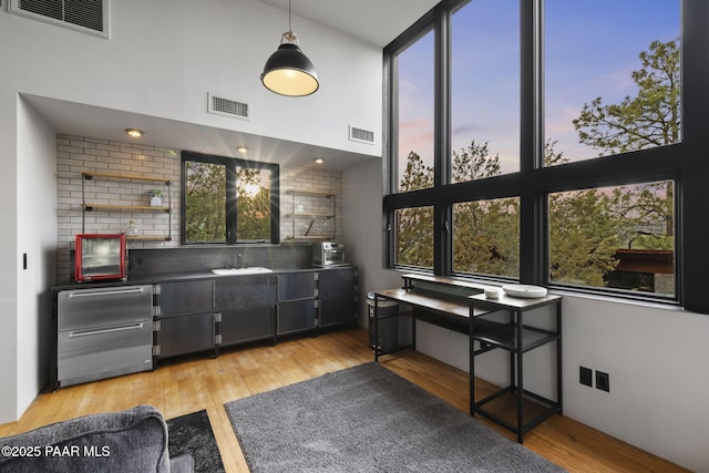 51 Rill Rd, Prescott, AZ 86305 - bar featuring light wood-type flooring, plenty of natural light, a sink, and dishwasher