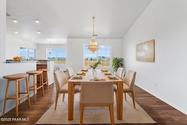 dining room with baseboards, dark wood-style flooring, and a chandelier