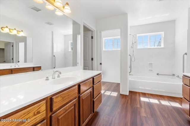 full bath with visible vents, wood finished floors, and vanity