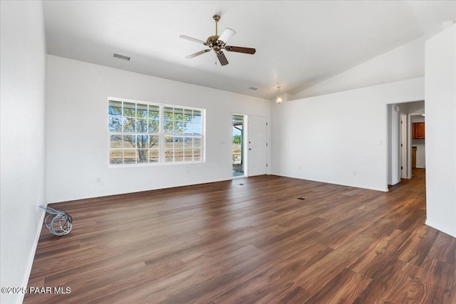 empty room featuring lofted ceiling, a ceiling fan, wood finished floors, and visible vents