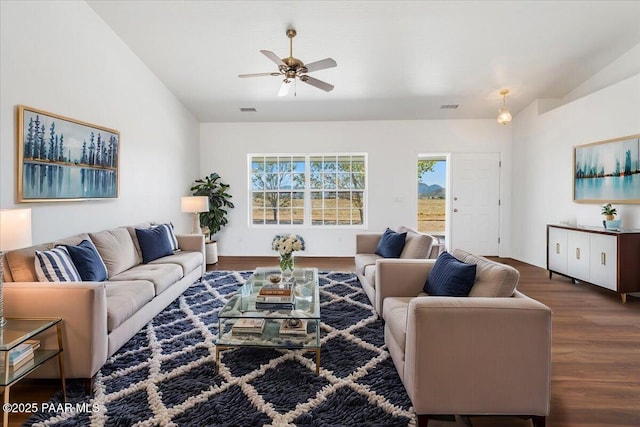 living area featuring visible vents, vaulted ceiling, wood finished floors, and ceiling fan
