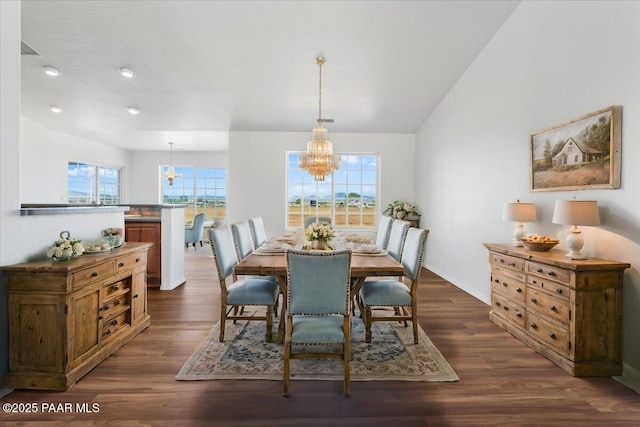 dining area with dark wood finished floors and a notable chandelier