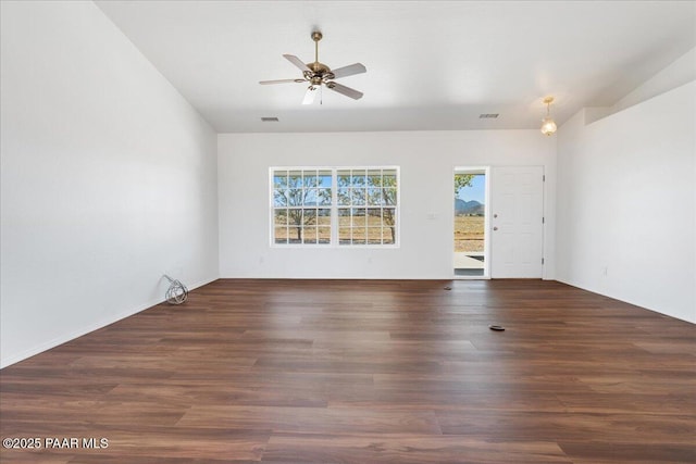 unfurnished room featuring wood finished floors, visible vents, and a ceiling fan