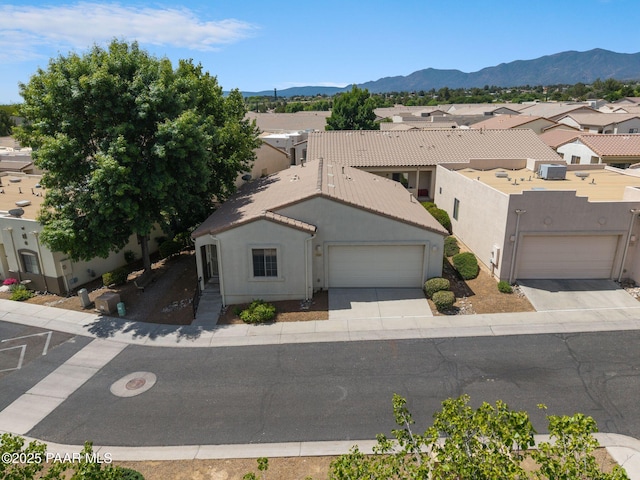 1735 Oro Dr, Cottonwood, AZ 86326 - view of front of home with concrete driveway, stucco siding, an attached garage, a mountain view, and a residential view
