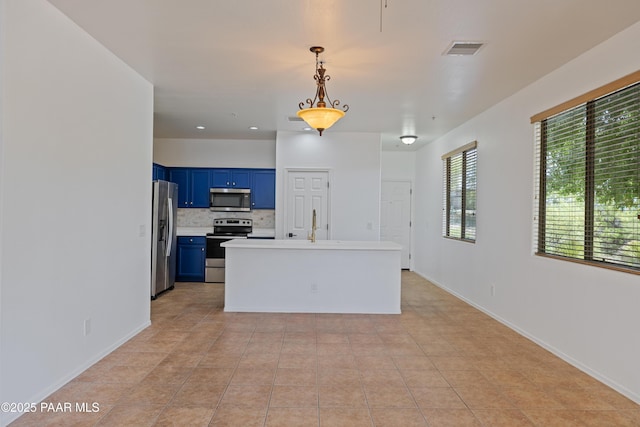 1735 Oro Dr, Cottonwood, AZ 86326 - kitchen with appliances with stainless steel finishes, blue cabinets, light countertops, hanging light fixtures, and baseboards