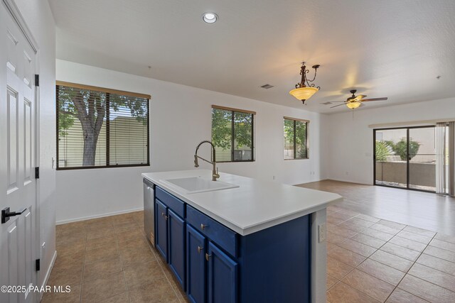 1735 Oro Dr, Cottonwood, AZ 86326 - kitchen featuring blue cabinets, a sink, dishwasher, light tile patterned flooring, and a ceiling fan