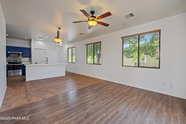1735 Oro Dr, Cottonwood, AZ 86326 - unfurnished living room featuring wood finished floors, ceiling fan, baseboards, a sink, and recessed lighting