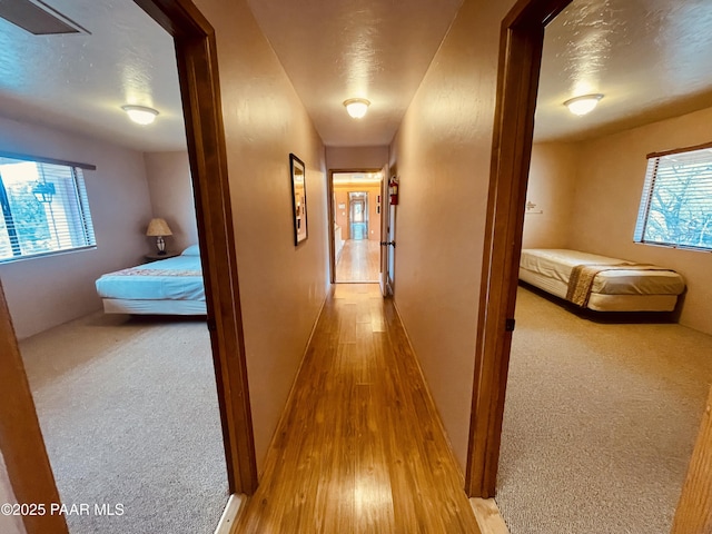 28555 N Feather Mountain Rd, Paulden, AZ 86334 - hall featuring wood finished floors, baseboards, and a textured ceiling