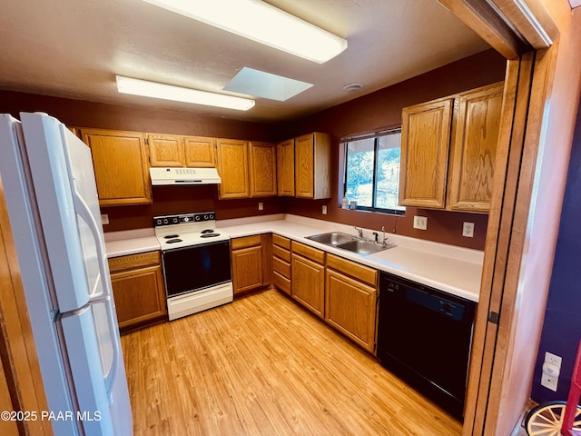 28555 N Feather Mountain Rd, Paulden, AZ 86334 - kitchen with white appliances, a sink, under cabinet range hood, light wood finished floors, and light countertops