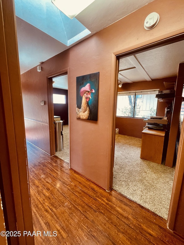 28555 N Feather Mountain Rd, Paulden, AZ 86334 - hallway featuring a skylight and wood finished floors