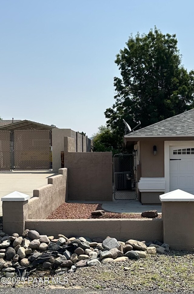 6217 N Little Papoose Dr, Prescott Valley, AZ 86314 - view of side of property featuring stucco siding and a gate