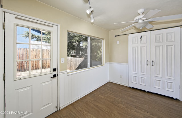 entryway with ceiling fan, dark wood-type flooring, a wealth of natural light, and track lighting