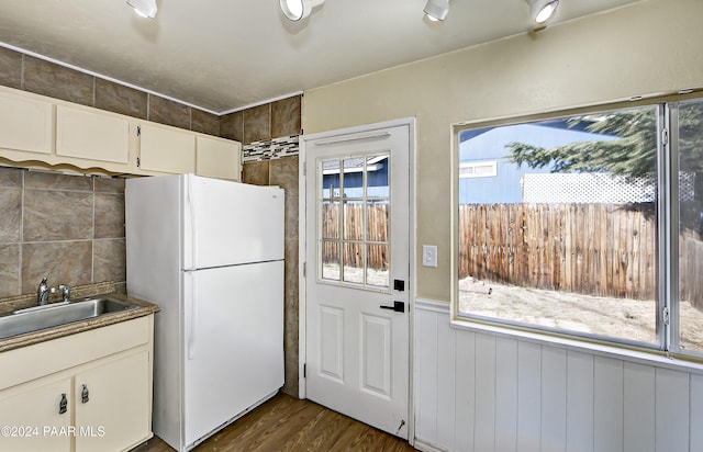 kitchen featuring white cabinets, plenty of natural light, and white fridge