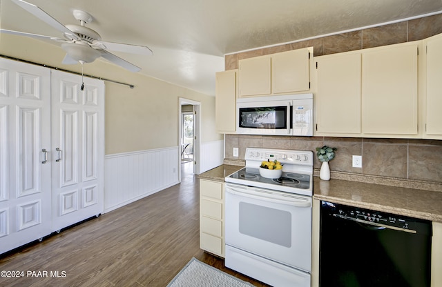 kitchen featuring white appliances, cream cabinets, hardwood / wood-style flooring, decorative backsplash, and ceiling fan