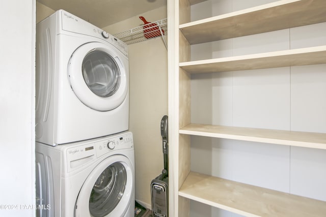 washroom featuring stacked washing maching and dryer