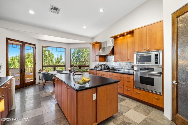 13175 N Bull Run Rd, Prescott, AZ 86305 - kitchen featuring stainless steel appliances, wall chimney range hood, dark countertops, french doors, and decorative backsplash