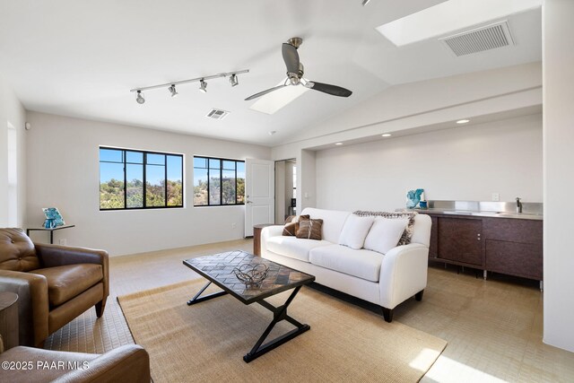 13175 N Bull Run Rd, Prescott, AZ 86305 - living room featuring a skylight, ceiling fan, light carpet, lofted ceiling, and track lighting