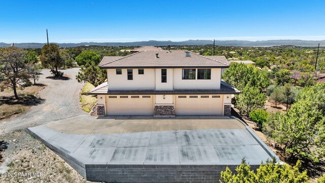 13175 N Bull Run Rd, Prescott, AZ 86305 - traditional-style house with a garage, driveway, stone siding, and a mountain view