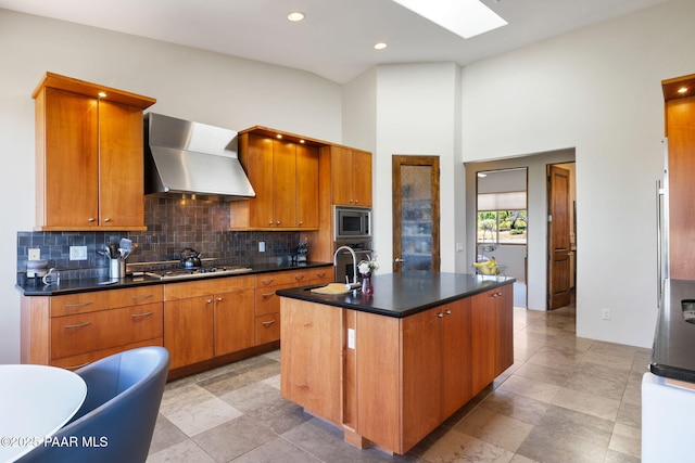 13175 N Bull Run Rd, Prescott, AZ 86305 - kitchen featuring wall chimney range hood, stainless steel appliances, a sink, dark countertops, and tasteful backsplash