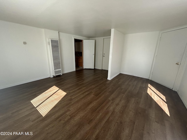 spare room with dark hardwood / wood-style floors